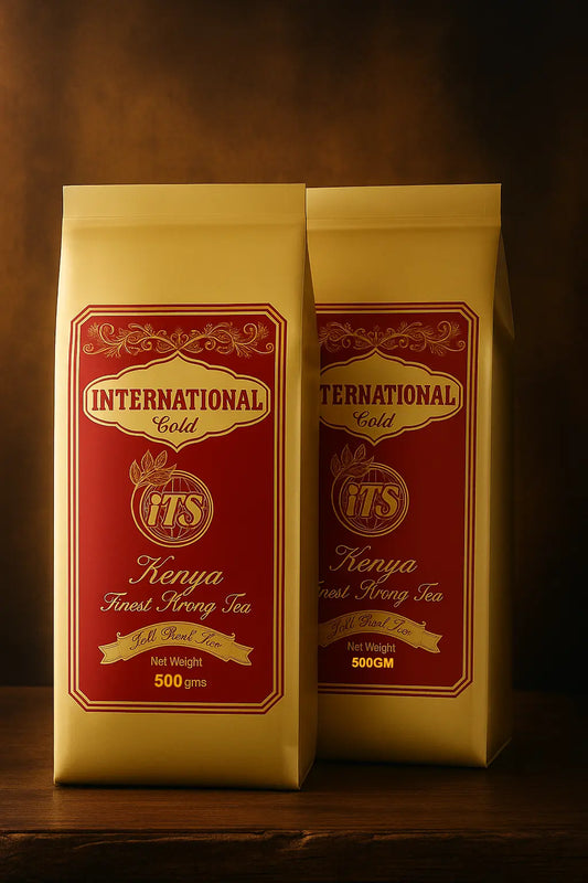 Two packages of International Gold Kenya Finest Strong Tea on a wooden surface with a dark background.