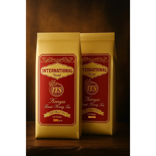 Two packages of International Gold Kenya Finest Strong Tea on a wooden surface with a dark background.